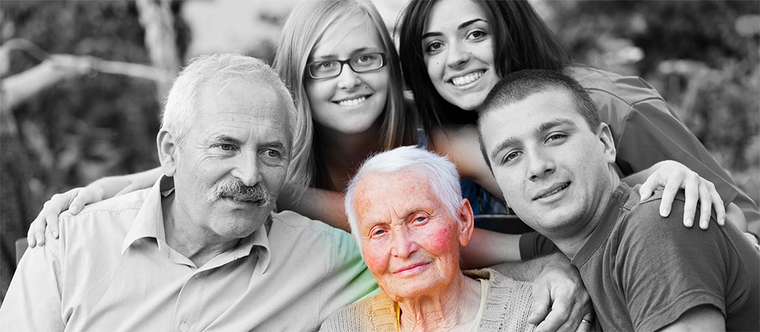 black and white family photograph with the grandmother in the center of frame in full colour