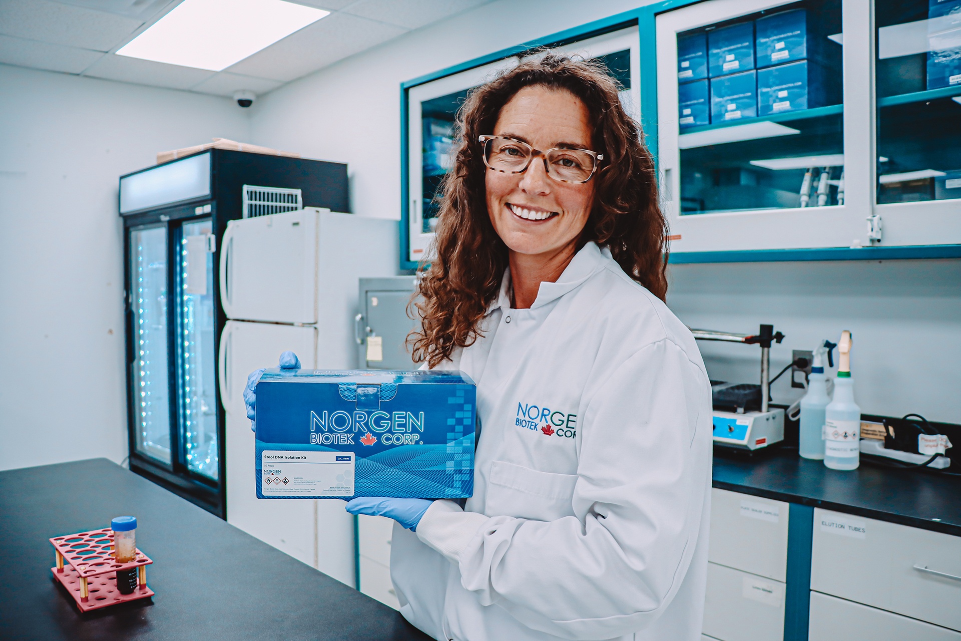 Norgen research scientist holding a Norgen Stool Isolation Kit