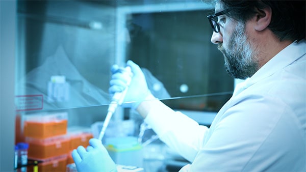 Norgen scientist using a pipette